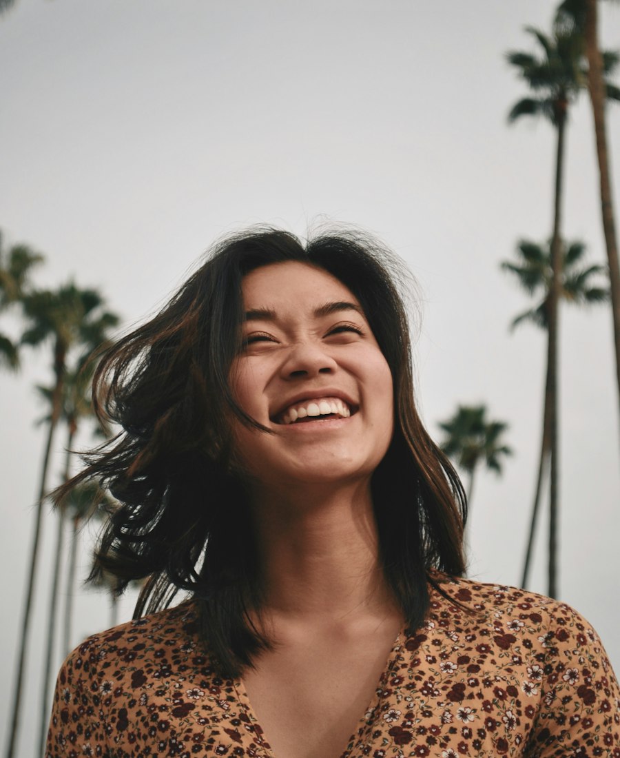 A woman laughing with her eyes closed